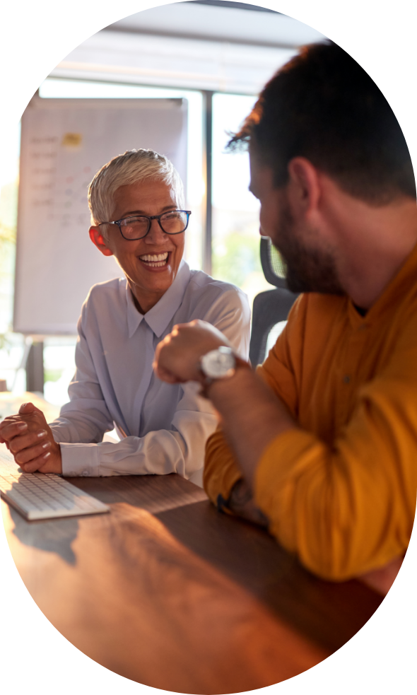 woman in glasses smiling while talking with man about a suboxone treatment clinic