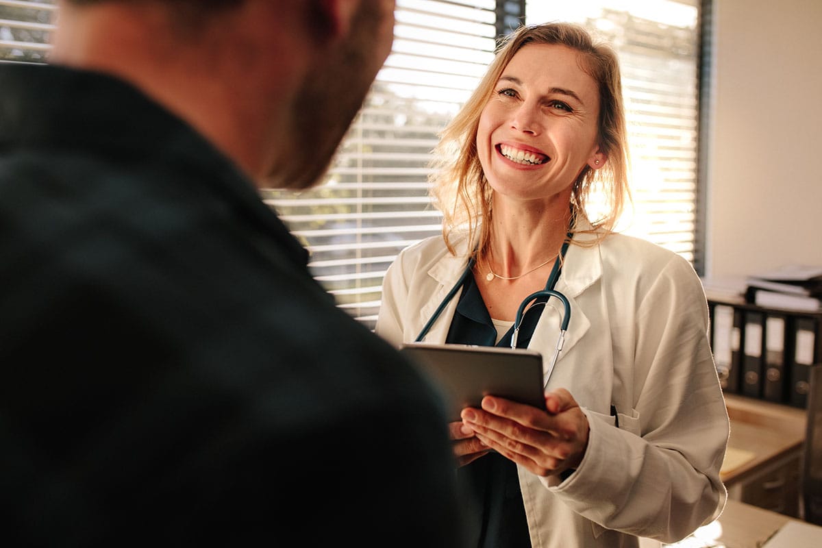 woman holding chart explains what medication-assisted treatment is